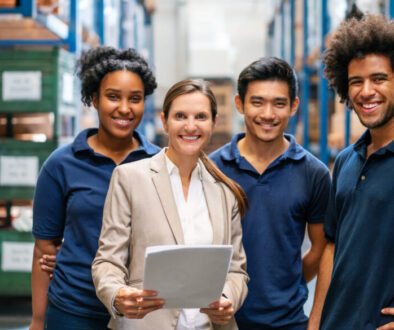 Warehouse manager with workers in factory